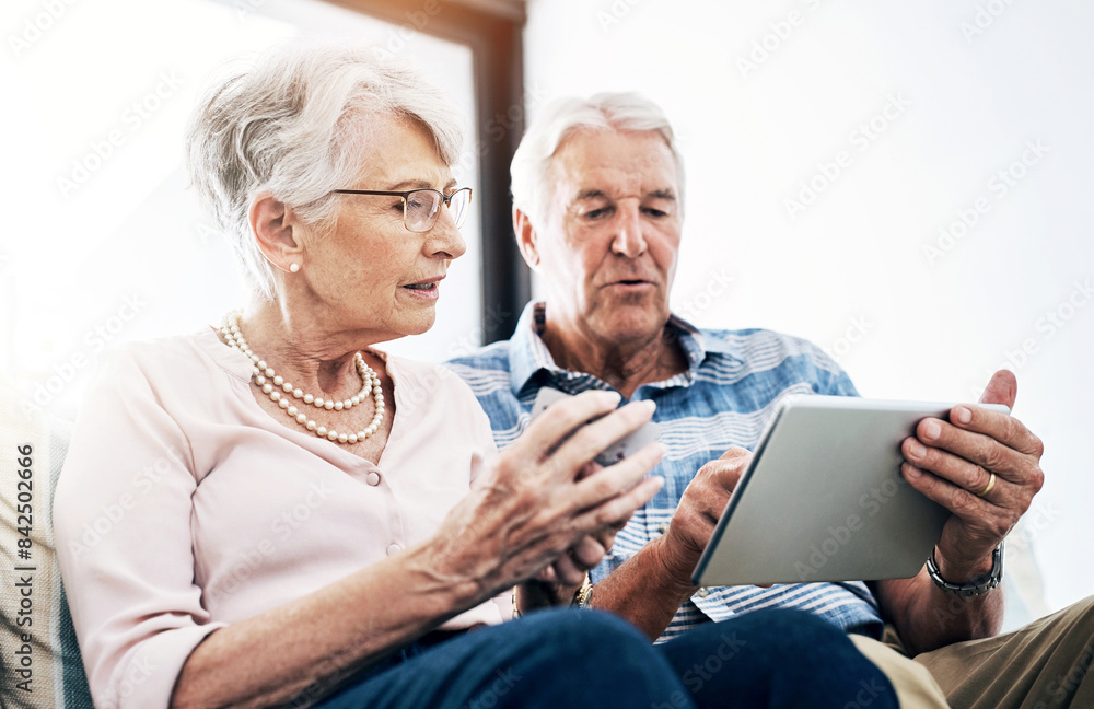 Mature couple, tablet and browsing with credit card in house for online shopping in living room. Streaming, movies and subscription with internet banking, digital purchase and transaction in home. Mature couple, tablet and browsing with credit card in house for online shopping in living room. Streaming, movies and subscription with internet banking, digital purchase and transaction in home.