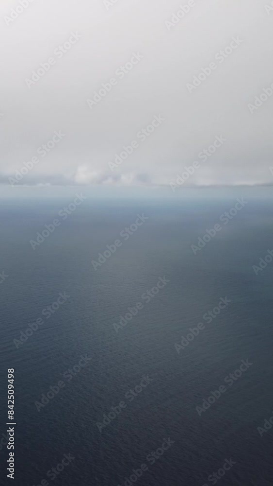 Aerial vertical view. Dramatic moody and gloomy rain clouds over sea. Abstract aerial nature summer ocean sunset sea and sky. Horizon. Vacation, travel and holiday concept. Weather and climate change Aerial vertical view. Dramatic moody and gloomy rain clouds over sea. Abstract aerial nature summer ocean sunset sea and sky. Horizon. Vacation, travel and holiday concept. Weather and climate change