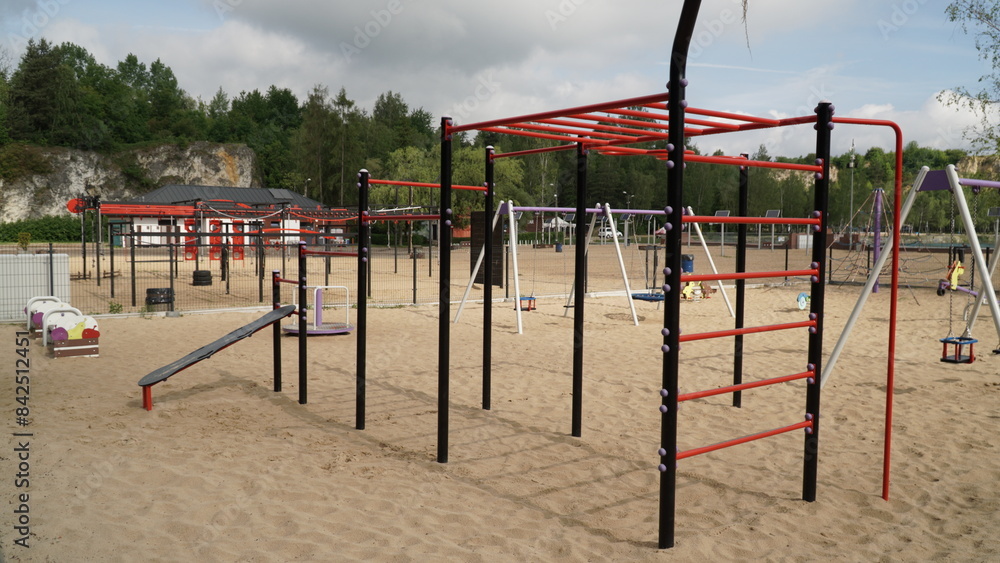 Outdoor Gym on Sand, Connected with Children's Playground A vibrant scene showcasing an outdoor gym situated on sandy ground, seamlessly connected with a children's playground. The gym equipment offer Outdoor Gym on Sand, Connected with Children's Playground A vibrant scene showcasing an outdoor gym situated on sandy ground, seamlessly connected with a children's playground. The gym equipment offer
