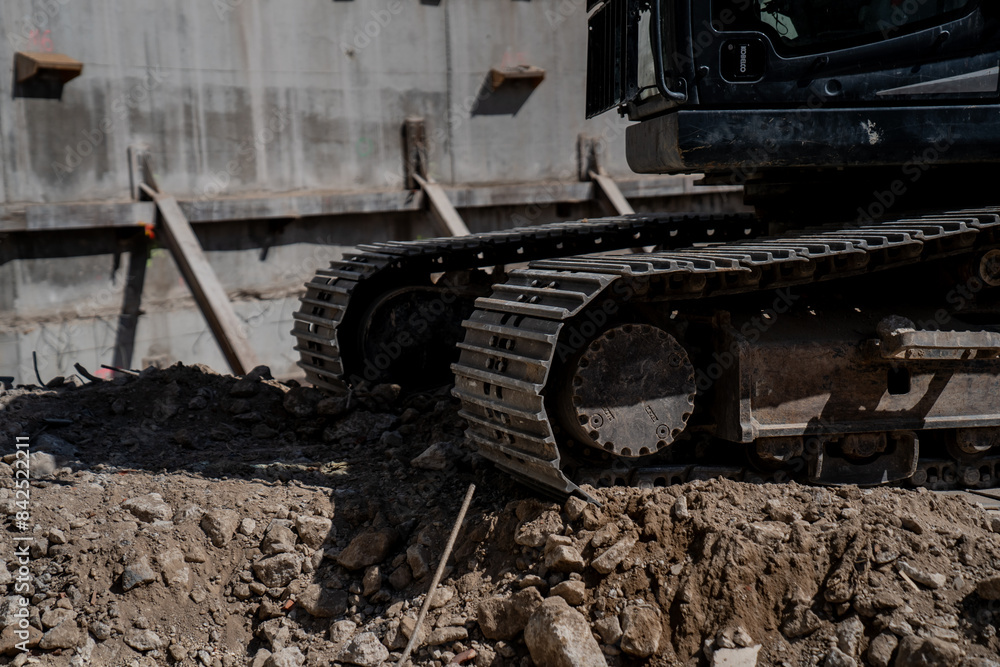 Excavator close up of track pad, grouser pad, track chains and rails for big several ton heavy excavating construction machinery Excavator close up of track pad, grouser pad, track chains and rails for big several ton heavy excavating construction machinery