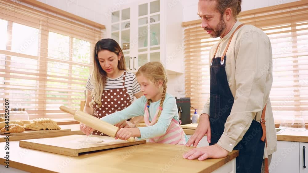 Caucasian young couple baking bakery with daughter in kitchen at home. Caucasian young couple baking bakery with daughter in kitchen at home.