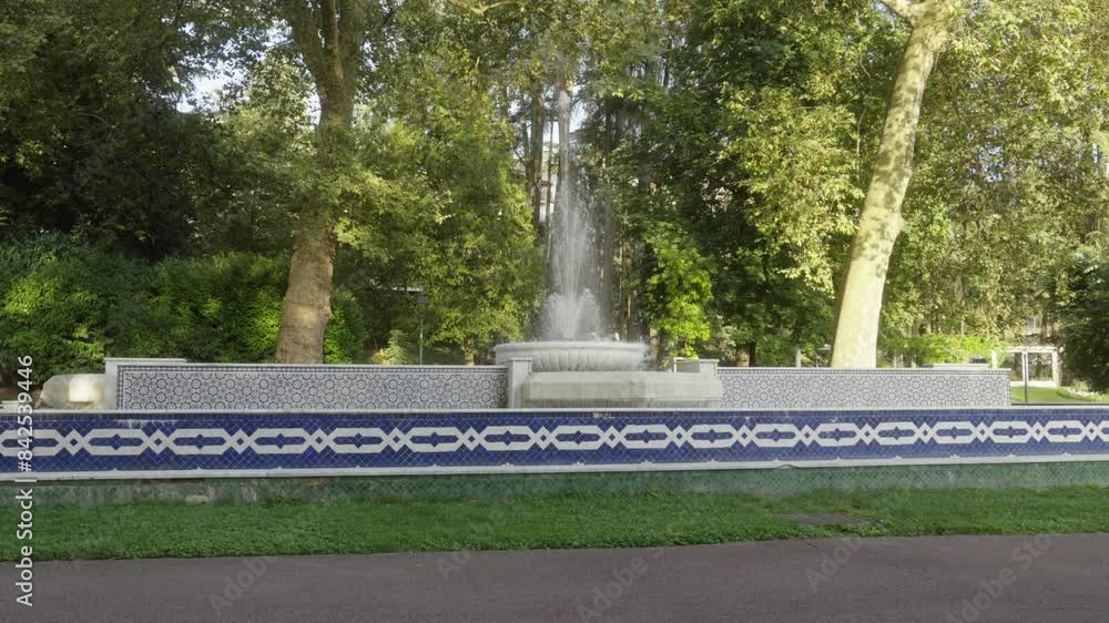 Fountain with water flow along green garden under sunlight static shot panoramic Fountain with water flow along green garden under sunlight static shot panoramic