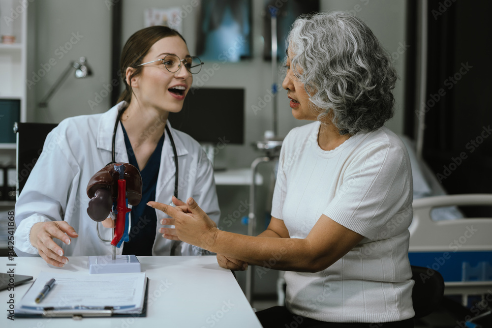 Female doctor consulting senior old patient filling form at consultation, talking to senior old patient filling signing medical paper at appointment visit in clinic. Female doctor consulting senior old patient filling form at consultation, talking to senior old patient filling signing medical paper at appointment visit in clinic.