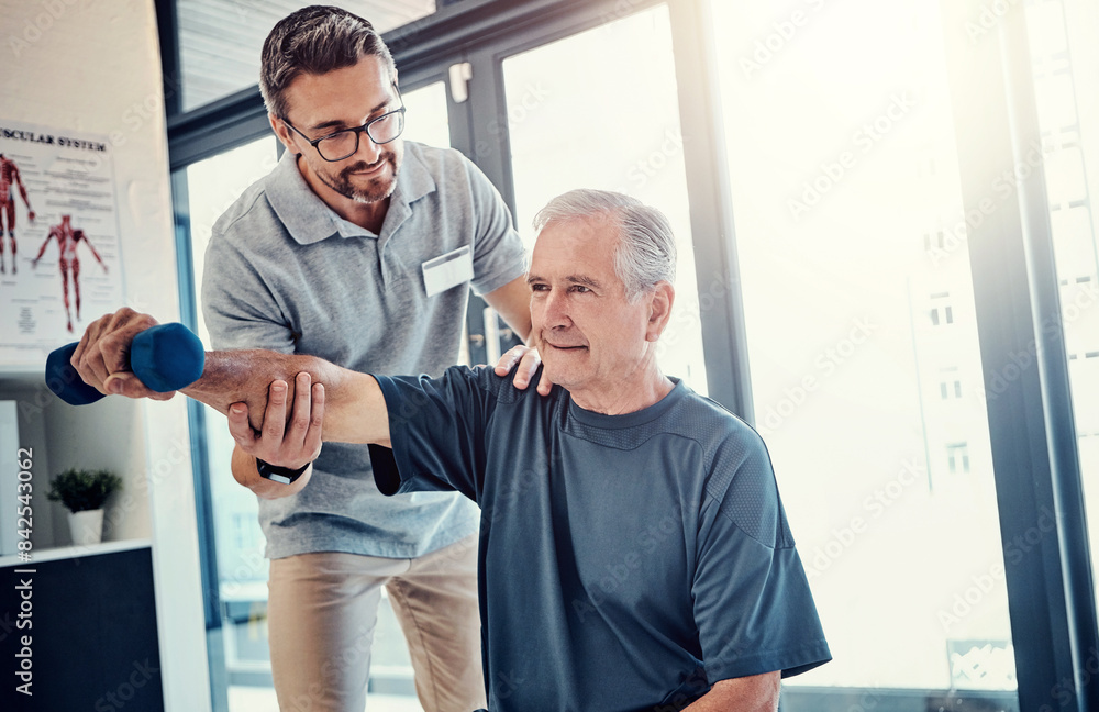 Obraz premium Senior man, physiotherapist and dumbbell with help for progress, recovery and balance for wellness. People, healthcare and rehabilitation from injury with support, care and strong muscle at clinic
