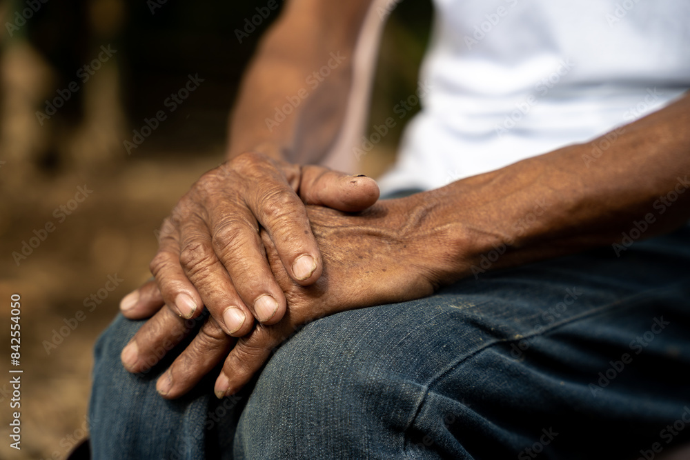 Fototapeta premium Close up of elderly oldman hands on wooden table.
