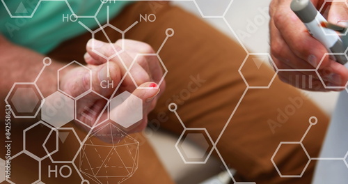 Image of chemistry formulas test over patient using glucose meter