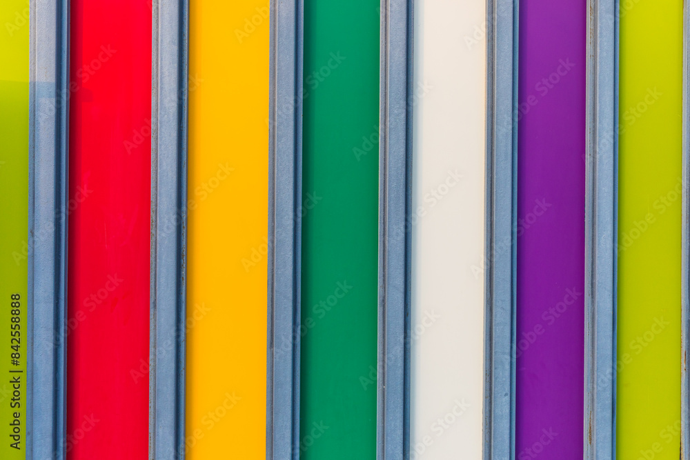 wooden fence painted in multi-colored stripes wooden fence painted in multi-colored stripes