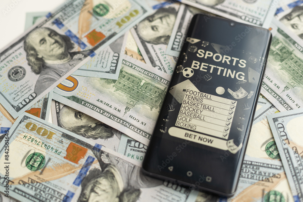 dollars and euros, smartphone with sports bet application dollars and euros, smartphone with sports bet application