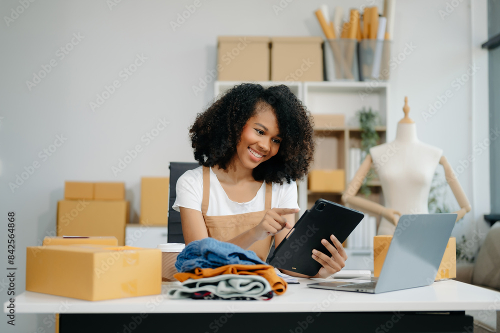 Asian young woman SME working using smartphone or tablet taking receive and checking online purchase shopping order Asian young woman SME working using smartphone or tablet taking receive and checking online purchase shopping order