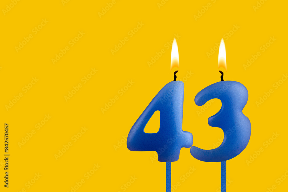 Blue candle number 43 - Birthday on yellow background Blue candle number 43 - Birthday on yellow background