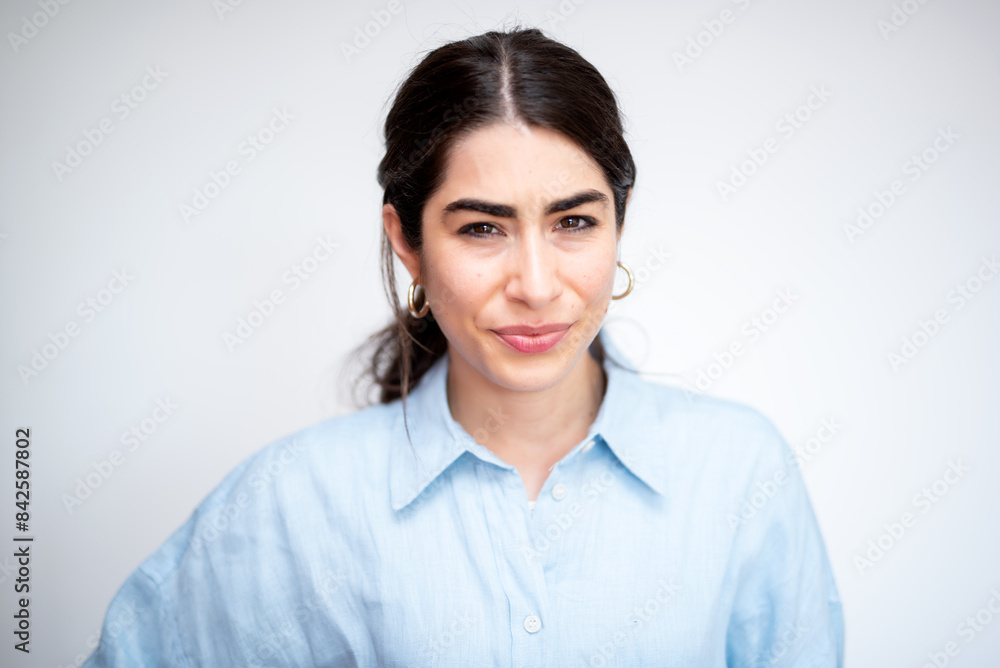 beautiful brunette short-sighted woman with light blue shirt on white background beautiful brunette short-sighted woman with light blue shirt on white background