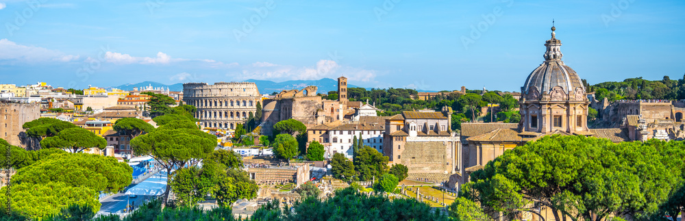 A panoramic view of the Roman Forum and Colosseum in Rome, Italy. The iconic amphitheater stands prominently in the distance, while ancient ruins and modern buildings fill the foreground. A panoramic view of the Roman Forum and Colosseum in Rome, Italy. The iconic amphitheater stands prominently in the distance, while ancient ruins and modern buildings fill the foreground.