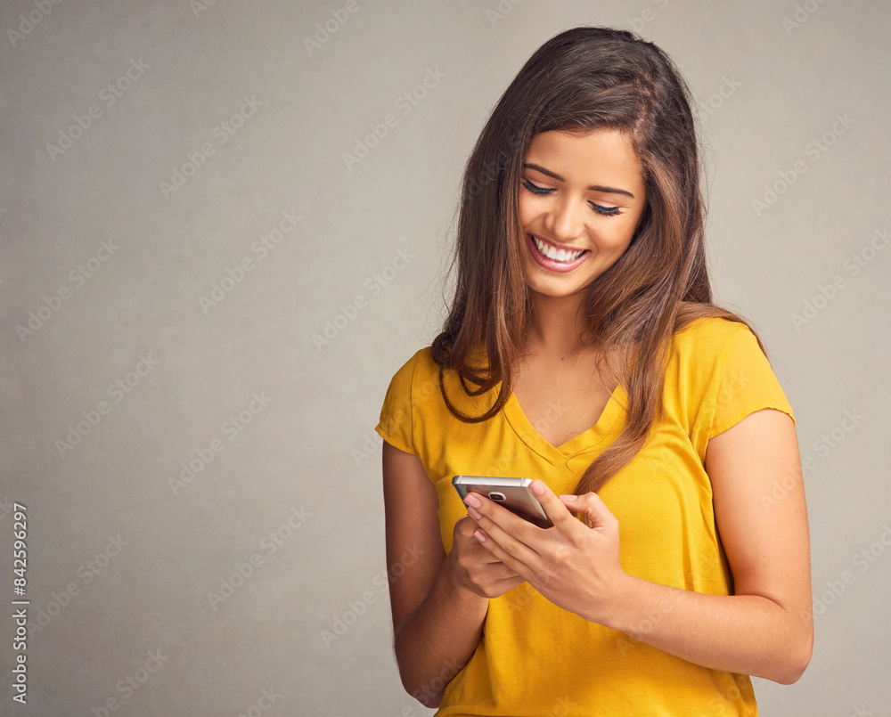 Woman, smile and notification with smartphone in studio background for social media, networking and online dating. Female person, happy and satisfied with good news, text message and mockup space Woman, smile and notification with smartphone in studio background for social media, networking and online dating. Female person, happy and satisfied with good news, text message and mockup space