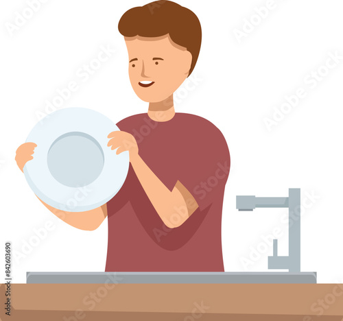 Young man is washing dishes in the kitchen sink, holding a clean plate