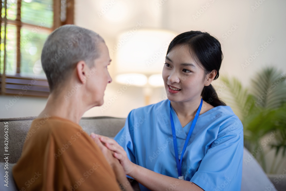 Asian caregiver holding hands with elderly woman at home. Concept of elderly care and emotional support Asian caregiver holding hands with elderly woman at home. Concept of elderly care and emotional support