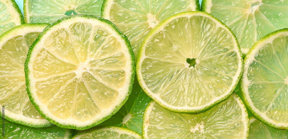 Slices of fresh lime as background, closeup Slices of fresh lime as background, closeup