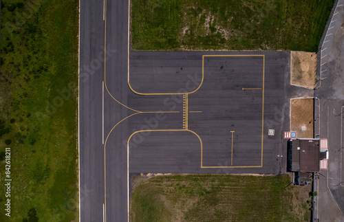 Vertical view of passenger terminal and stopping point for planes and helicopters on airfield