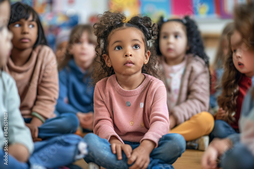 a group of children sitting on the floor in a classroom