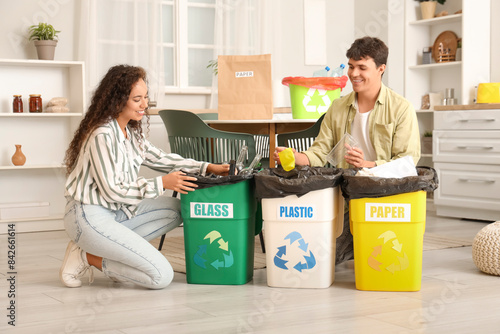 Young couple with garbage c...