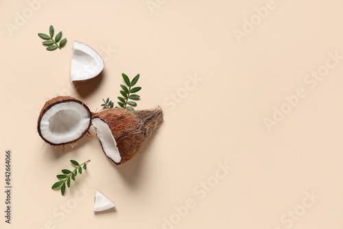 Fresh coconuts and leaves on beige background