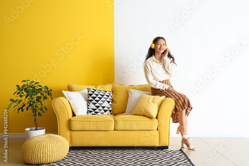 Young Asian woman in headph...