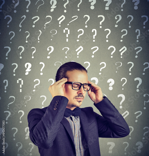 Fotografie Stressed overburdened young man has too many questions