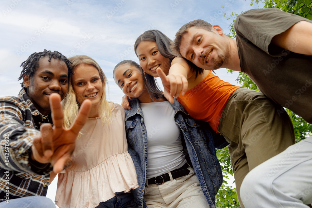 Portrait of multiracial group of generation z boys and girls looking at camera. Group of friends outdoors Portrait of multiracial group of generation z boys and girls looking at camera. Group of friends outdoors