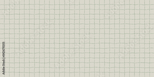 Textured sheet of green wavy checkered paper with a stipple effect. Cute background in soft retro color, irregular geometric pattern, notebook page.