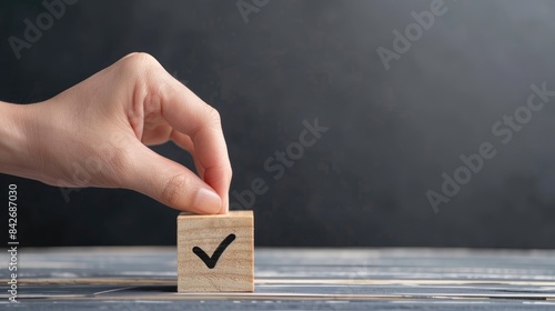 Placing Hand with checkmark on wooden block for document and project approval concept photo