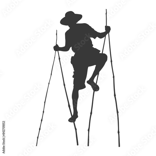 Silhouetted Man in Straw Hat Climbing Stilt-Like Bamboo.