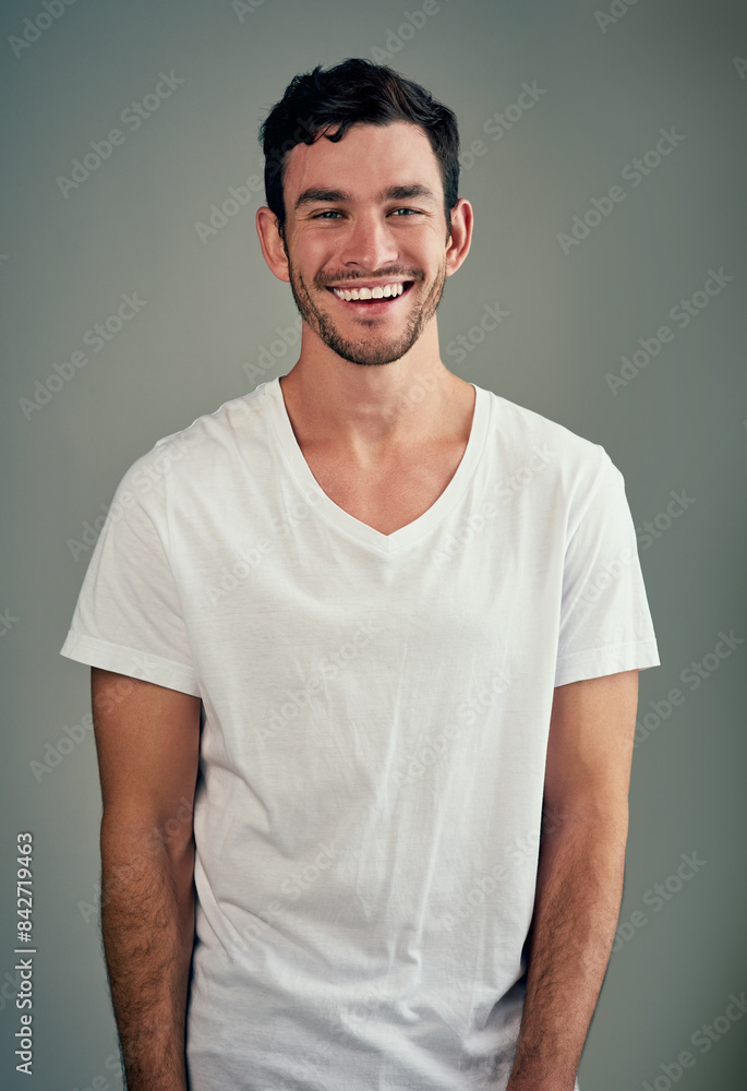 Happy, laughing and portrait of man with confidence in studio for good mood, joy and funny joke. Relax, male person and face with smile for humor, comedy meme and satisfaction on gray background Happy, laughing and portrait of man with confidence in studio for good mood, joy and funny joke. Relax, male person and face with smile for humor, comedy meme and satisfaction on gray background