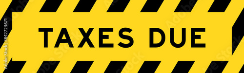 Yellow and black color with line striped label banner with word taxes due