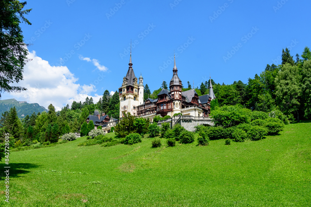 Beautiful neo-Renaissance building of Peles Castle (Castelul Peles) near Bucegi Mountains (Muntii Bucegi) in a sunny summer day in Sinaia town, Romania . Beautiful neo-Renaissance building of Peles Castle (Castelul Peles) near Bucegi Mountains (Muntii Bucegi) in a sunny summer day in Sinaia town, Romania .