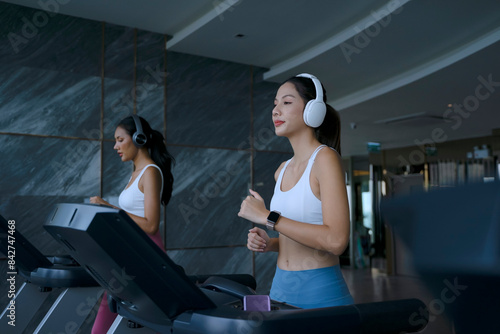 Pretty women are exercising at high rise building fitness center.