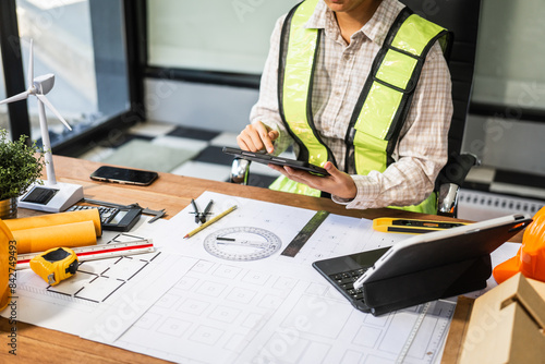 Canvastavla Female architect engineer is drafting blueprints using CAD software, focusing on