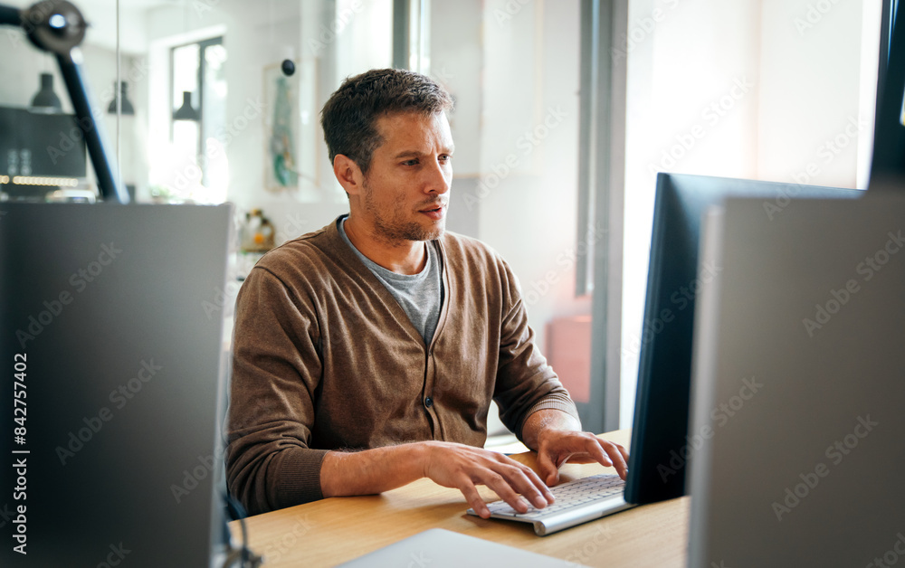 Programmer, web developer, designer working at office comparing mobile and desktop website versions Programmer, web developer, designer working at office comparing mobile and desktop website versions