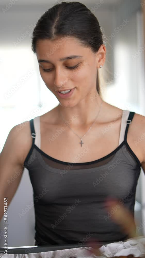 A woman bakes in a modern kitchen, preparing a meal with fresh ingredients indoors