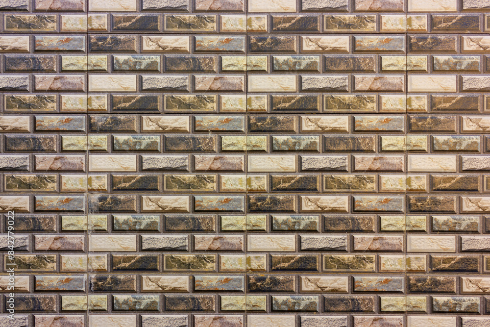 Fototapeta premium Tiled wall of ceramic with pattern motif in mixed color