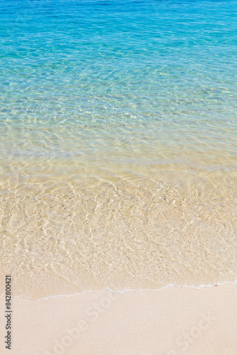 Ripples of the crystal-clear sea waters near the sand of Praia do Dentista, in Ilha Grande, RJ, Brazil.
