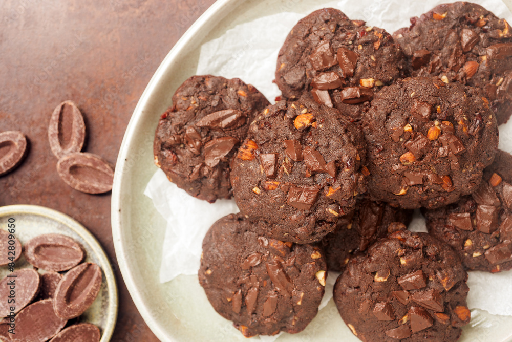 double chocolate cookies in ceramic plate on rusty background. double chocolate cookies in ceramic plate on rusty background.