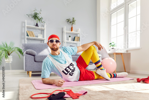 Fotografie Portrait of a funny man lying on the floor during workout training or resting after exercise at home gym