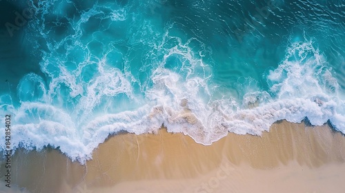 Aerial view of a beautiful sandy beach with turquoise ocean waves