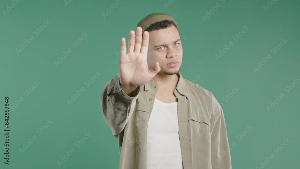 Serious man showing rejecting gesture by stop palm sign. Not allow, prohibition Serious man showing rejecting gesture by stop palm sign. Not allow, prohibition