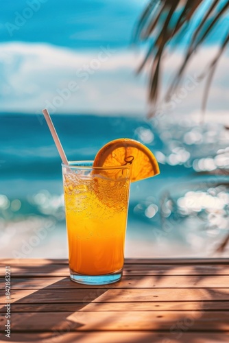 A vibrant orange cocktail with a slice of orange and a straw  set on a wooden table with a stunning beach and ocean view in the background  capturing the essence of a perfect tropical getaway.