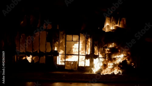 Intense Fire Burning Inside Building at Night