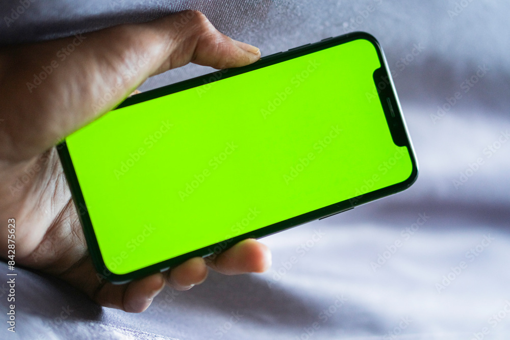 Smart phone with green screen held by person Smart phone with green screen held by person
