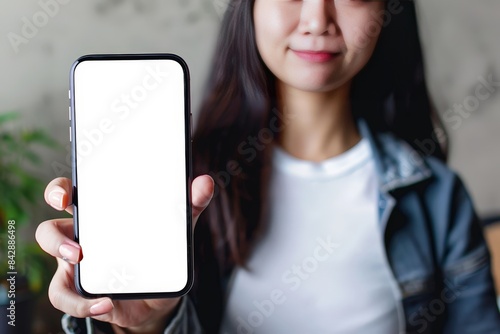 High-resolution mockup image of a woman showcasing a blank mobile phone screen.