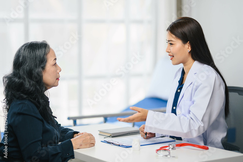 Wallpaper Mural Doctor woman doctor is talking to an older woman patient Torontodigital.ca