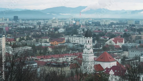 On a cloudy day, the view of Ljubljana from the hill captures the cityscape under a dramatic sky, highlighting its architectural beauty amidst the atmospheric conditions.


