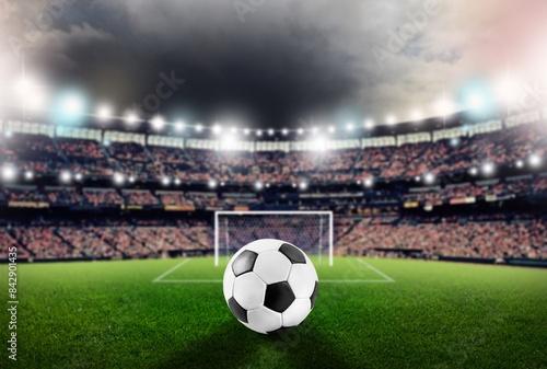 Classic soccer ball on green field in stadium © BillionPhotos.com